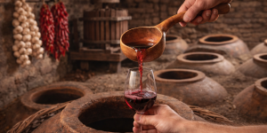 Authentic Georgian marani interior with qvevri, satsnakheli wine press, and traditional winemaking tools
